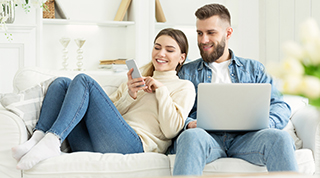 image of couple on laptop and phone